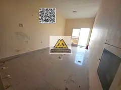 A spacious studio for annual rent in Al Hamidiya – Ajman, featuring a balcony with an open view an