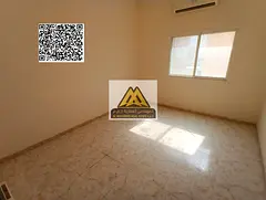 A spacious studio for annual rent in Al Rawda 3 – Ajman, featuring a separate kitchen and split AC