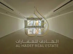 4BR apartment in Al Qasba, spacious layout, landlord-paid AC and maintenance, free parking, prime lo
