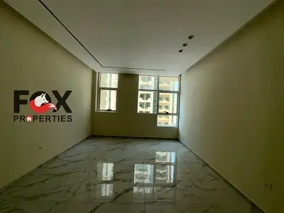1BR apartment for annual rent in Al Rashidiya Towers, Ajman, balcony with view, built-in wardrobes, prime location close to all services.