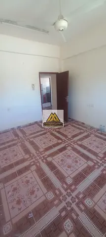 A spacious and well-maintained 2 bedroom apartment is now available for annual rent in Al Rumaila, Ajman, located on Al Karama Street in one of the mo