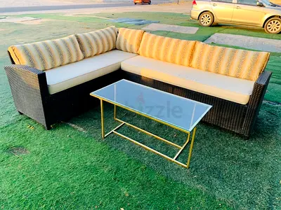 Outdoor rattan L-shaped sofa set with glass coffee table - used