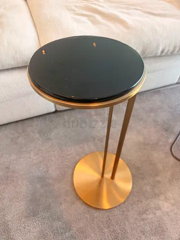 Small round gold side coffee table with black top - modern accent table