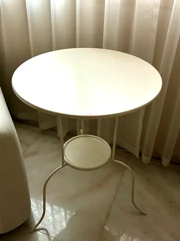 Small round white side table with lower shelf - good condition