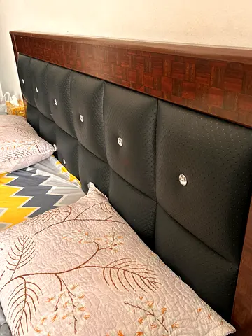 Queen size bed with padded leather headboard and wooden frame