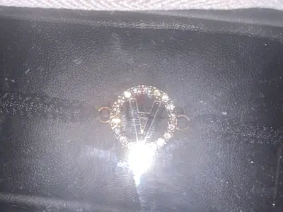 UNISEX Gold-tone circular pendant with V initial and crystal accents