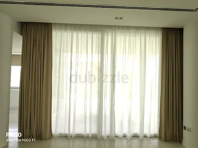 Full-length beige curtains with white sheer panels - set for living room