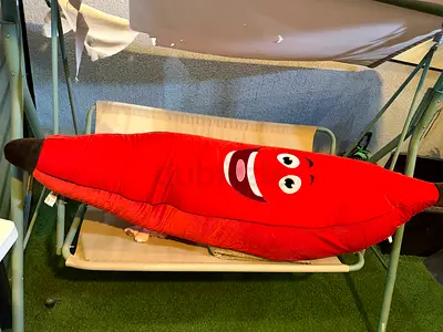 Large red smiling banana plush toy