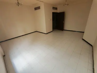 Two-bedroom apartment with a living room for annual rent, featuring built-in wardrobes and an excellent spacious layout.