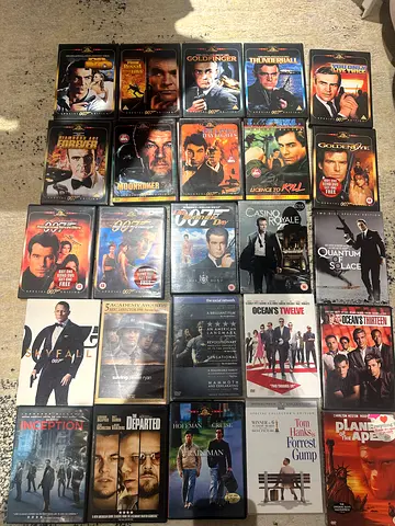 Box of assorted action movie DVDs (James Bond and more)