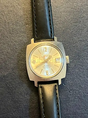 vintage Levis 21 rubis automatic Swiss Women’s watch with a black leather strap.