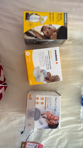 Nurture electric breast pumps with Medela disposable nursing pads and milk collector.Unused.
