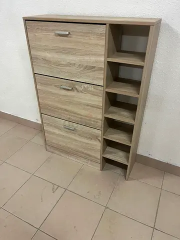 A natural wood-colored shoe cabinet with a wood finish and three foldable drawers.