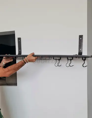 Wall-mounted metal rack with hooks for bar materials (industrial style)