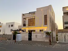 Luxury villa in Al Bahia, Ajman, with two floors and a rooftop terrace, featuring a swimming pool,