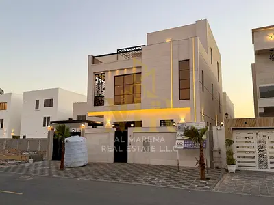 Luxury villa in Al Bahia, Ajman, with two floors and a rooftop terrace, featuring a swimming pool, ready for immediate occupancy and high-end finishes