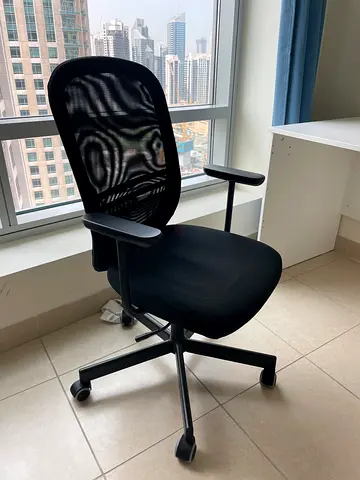 Black ergonomic office chair with mesh back and armrests