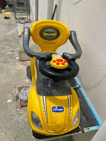 Yellow Chicco Ride-On Baby Car with Steering Wheel and Push Handle