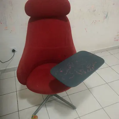 Red swivel study chair with attached writing tablet — good condition