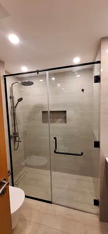 Modern frameless glass shower enclosure with black hardware (used) tile and marble