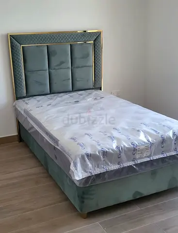 Elegant mint green bed frame with gold trim - clean and new