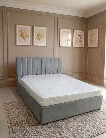Grey upholstered Queen size 150cm by 190cm bed with storage base and vertical channel headboard