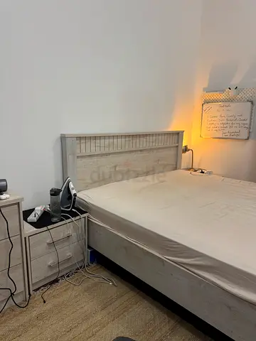 Kingsize wooden bed frame with extra cushioning mattress and matching bedside table  dressing table