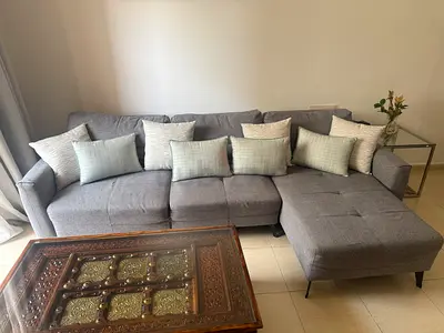 Grey L-shaped Fabric Sofa cum bed with Cushions - Good Condition