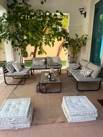 Outdoor patio sofa set with coffee table and cushions - good condition