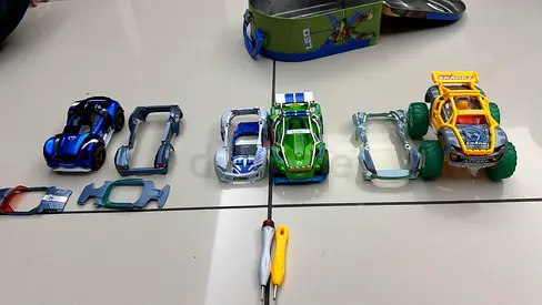 Lot of toy cars and replacement chassis parts — 5 cars + spares