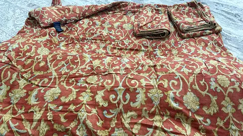 Used red-gold patterned rug — good condition, decorative design