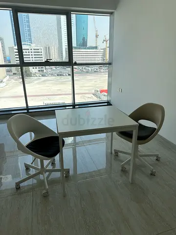 Small white office table with two modern swivel chairs