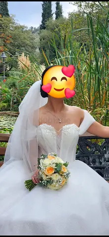 White off-shoulder strapless wedding dress with full skirt