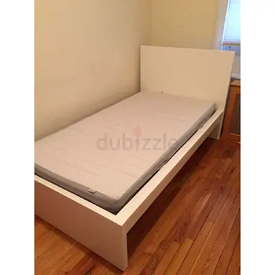 Single white wooden bed frame with mattress