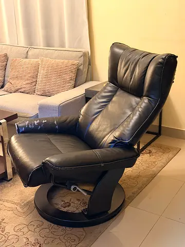 Black leather reclining lounge chair with swivel base