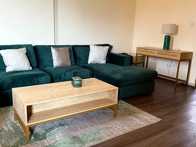Green L-shaped Sofa with Wooden Coffee Table and Console - Good Condition