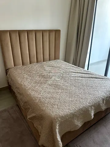 Upholstered queen bed frame and mattress with tall paneled headboard - beige