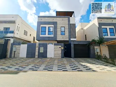 Luxury villa for sale in one of Ajman's best areas. Modern design, price includes water, electricity, and central air conditioning.