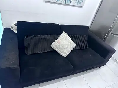 Three-seater black fabric sofa in good condition