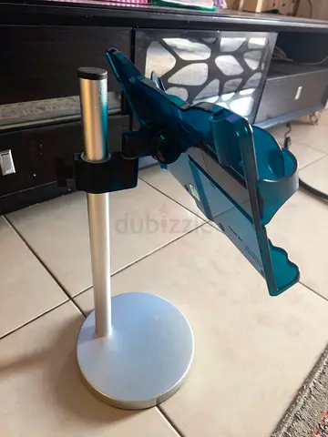 Adjustable metal desk stand with blue plastic phone/tablet holder