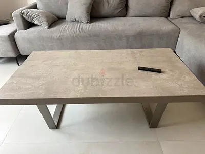 Modern concrete-look coffee table with metal legs - good condition.