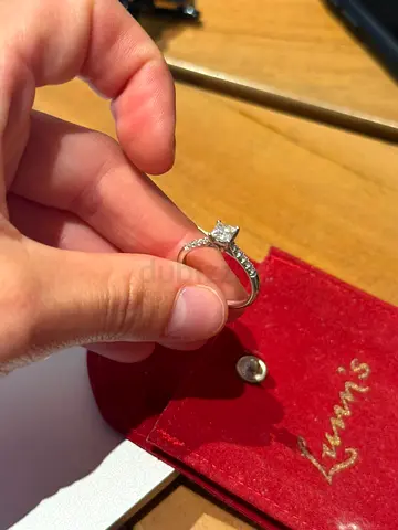 Classic solitaire engagement ring with channel-set side stones (size not specified)