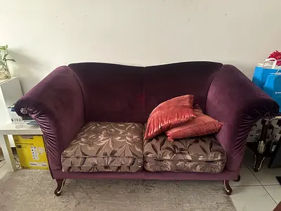 Purple velvet 2 and 3 seater sofa with patterned cushions
