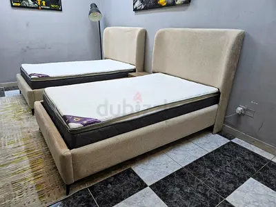 Pair of beige single beds with mattresses – good condition
