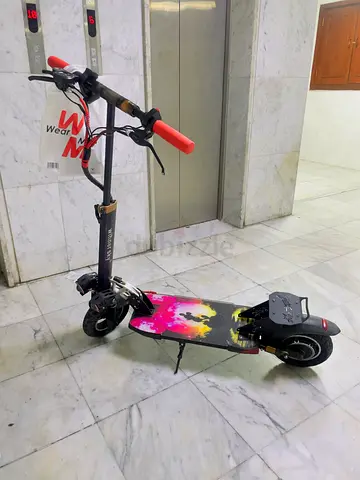 Used Electric Scooter with Wide Deck in Good Condition with charger and Remote Key.