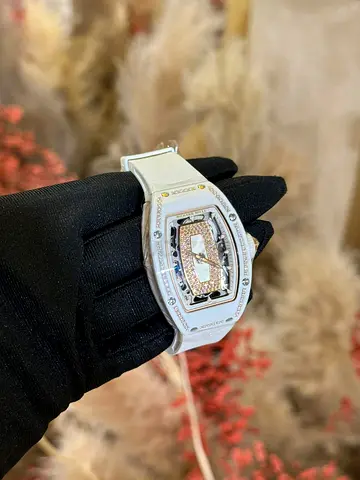 Richard Mille RM 07-01 with a diamond-encrusted bezel and a white rubber strap.