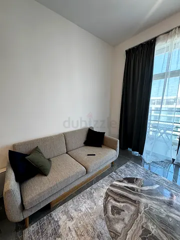 Light grey IKEA SMEDSTORP sofa with complimentary pillows