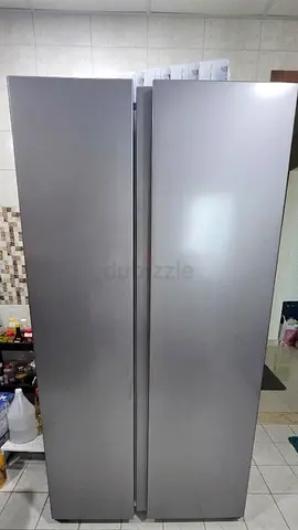 NEEDS New compressor. Side-by-side stainless finish refrigerator and freezer.