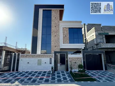 For Sale: Distinctive Modern Villa in Al Yasmeen, Ajman • 3 floors with an elegant stone facade. • 5 master bedrooms with built-in wardrobes. • Majlis with a separate entrance and washroom. • 2 spacio