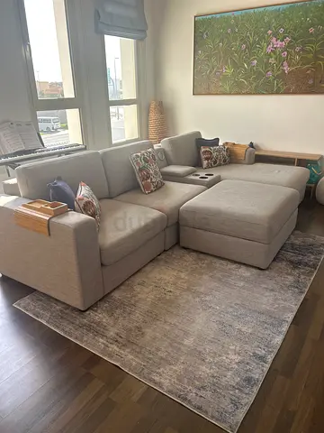 Light grey L-shaped sectional sofa with storage arm tray - excellent condition